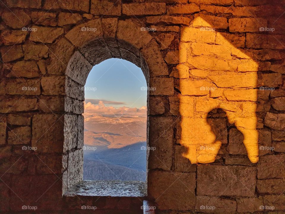 old tower inside with window and man shadow