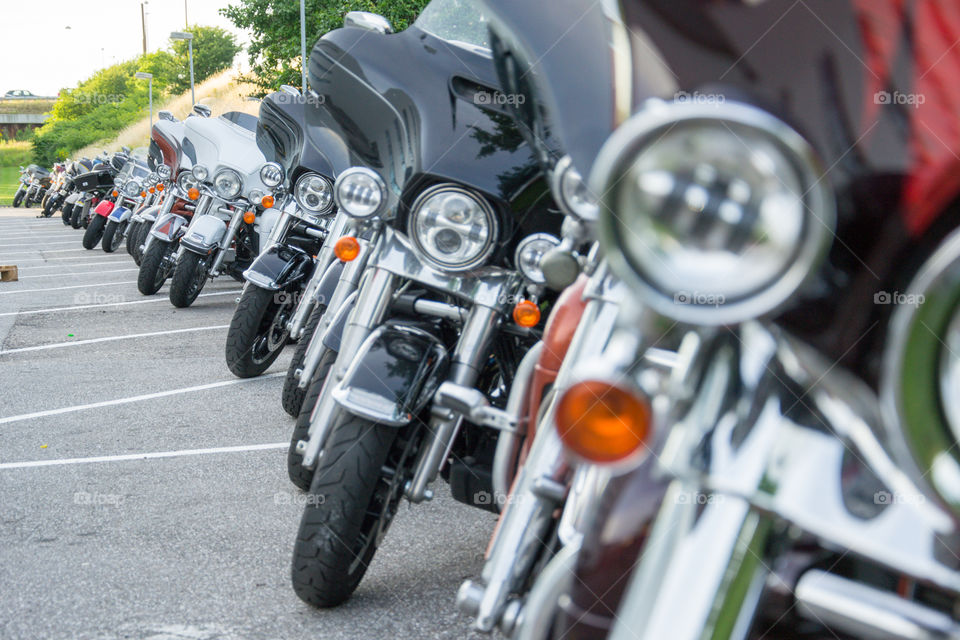 a large collection of motorcycles parked outside a hotel in Denmark.