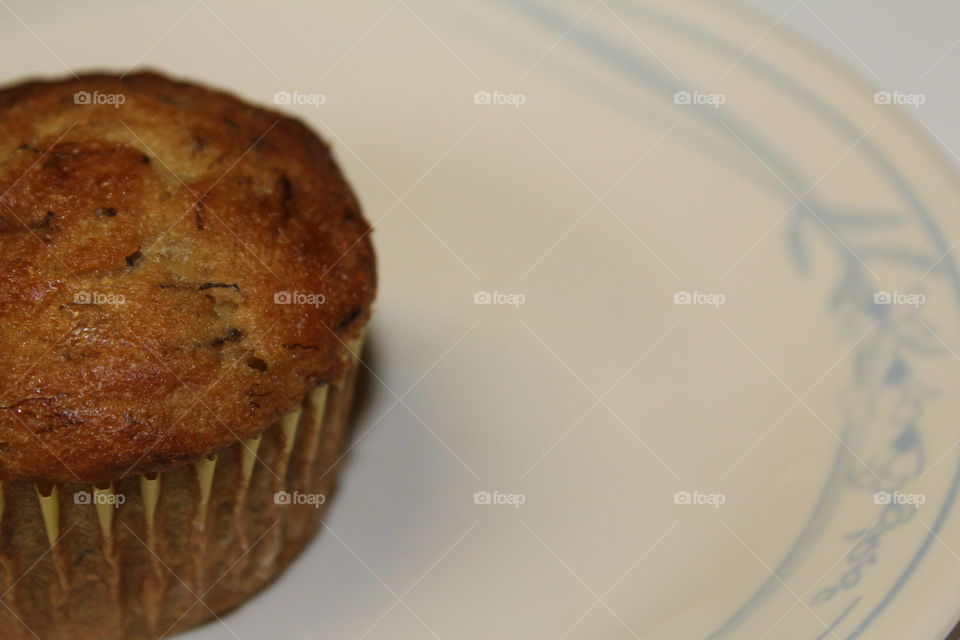 homemade banana muffin on a decorative plate