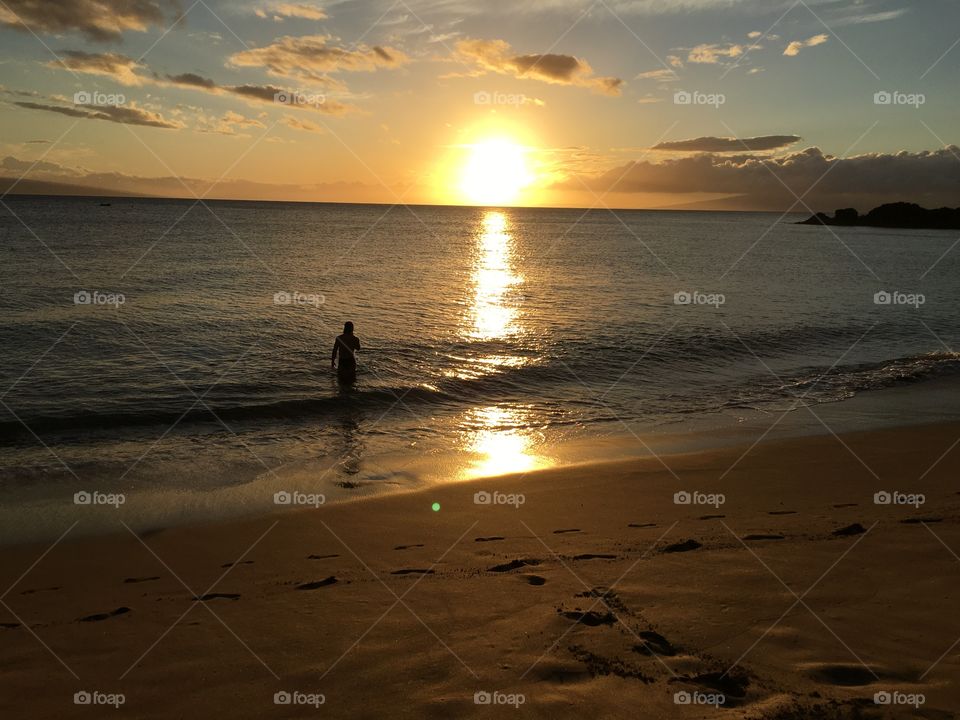 Silhouette of human walking on beach