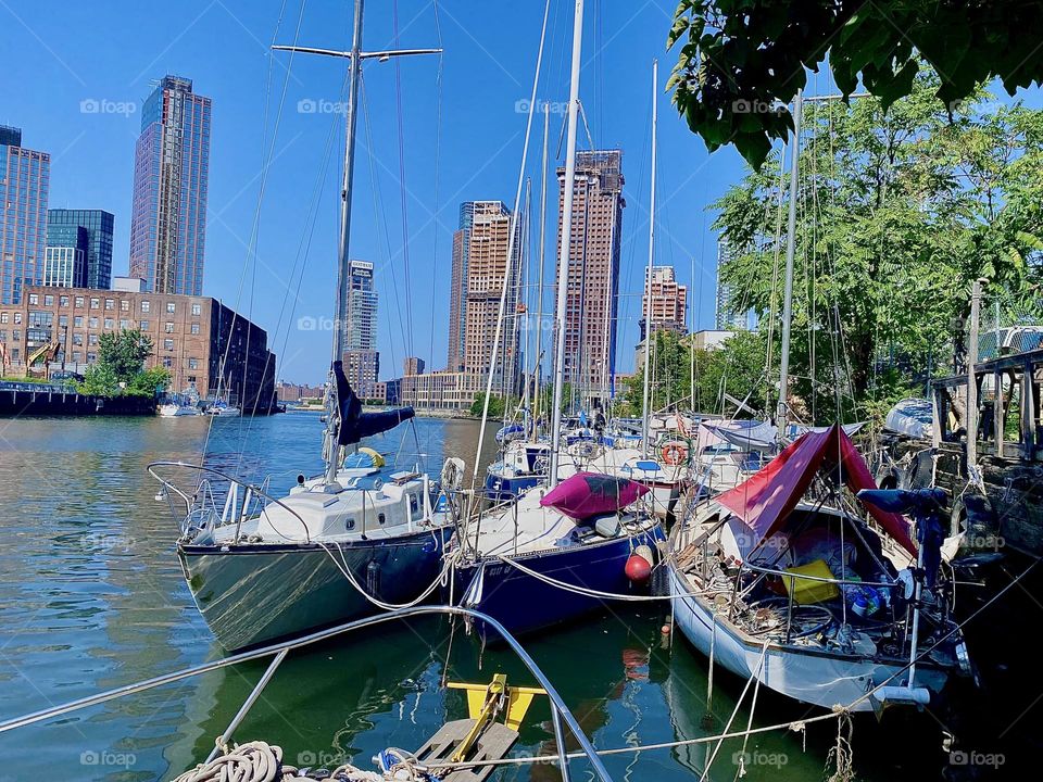 One day I stepped outside „Salvation“, our „1969 Luhrs“ cabin cruiser and took a look around. The boats at „Newtown Creek“ in LIC, Queens were lit up by the sun and the ocean sparkled brightly blue so I snapped a photo. 2023. Hypnotic Productions