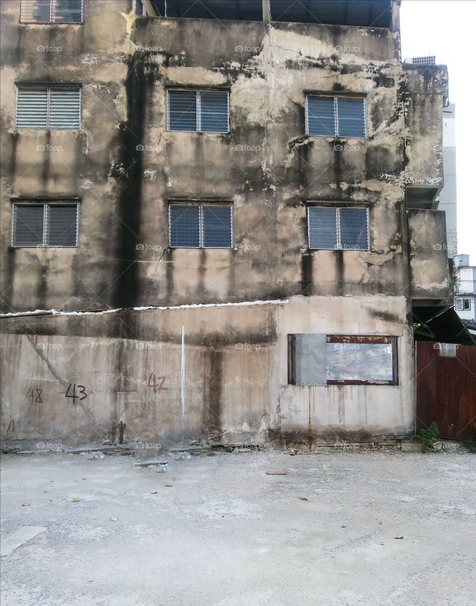 Old external wall with plaster cracks.