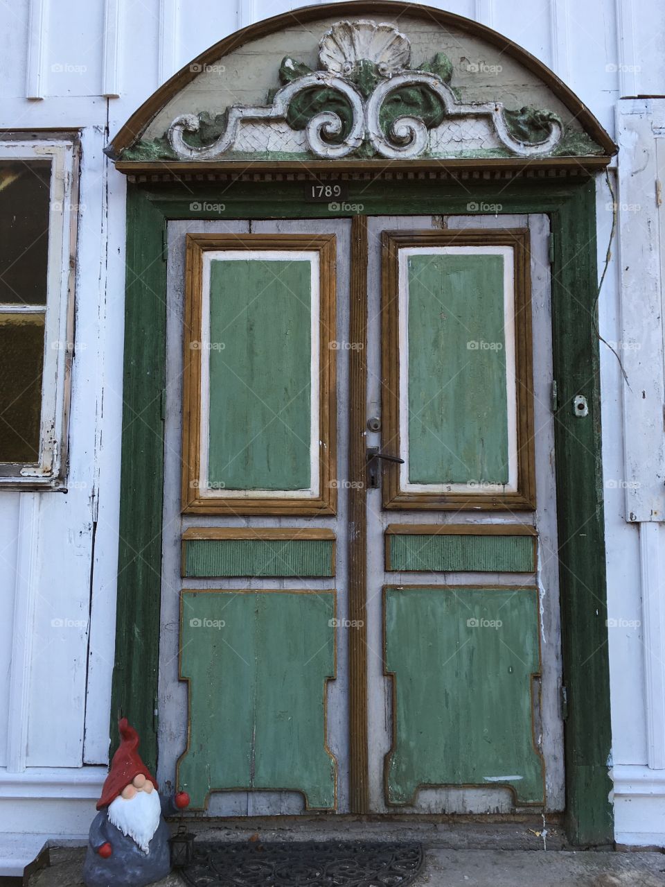 Old wooden door with gnome