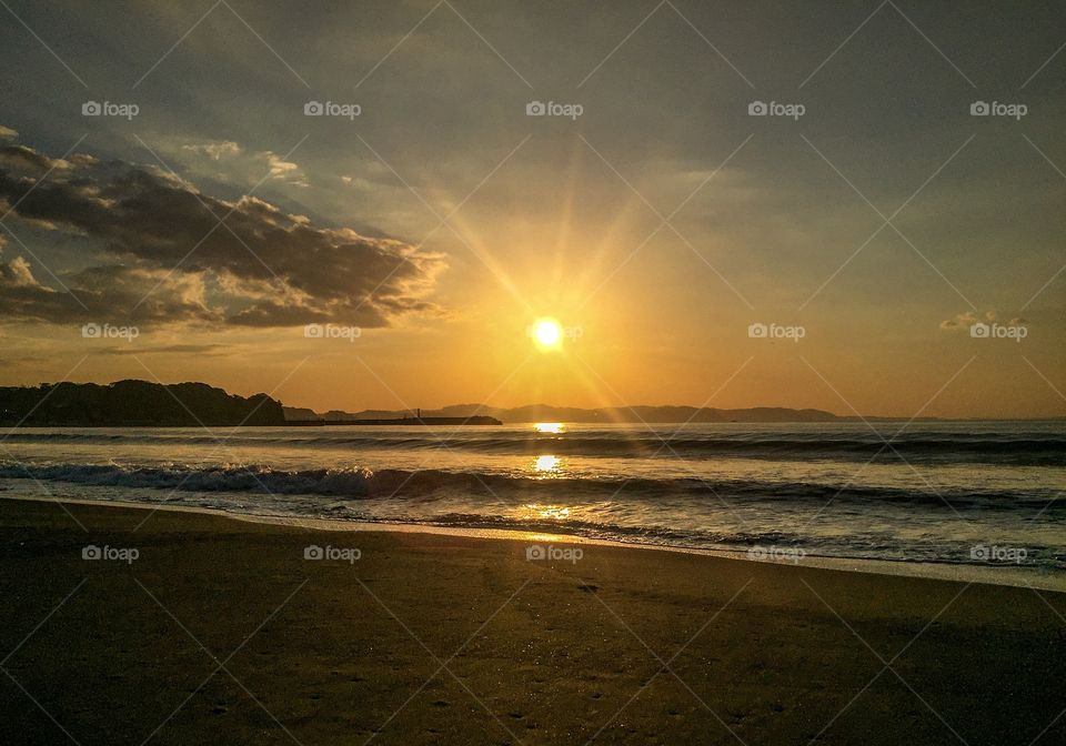 Beautiful Sun light reflection on the black beach and sea