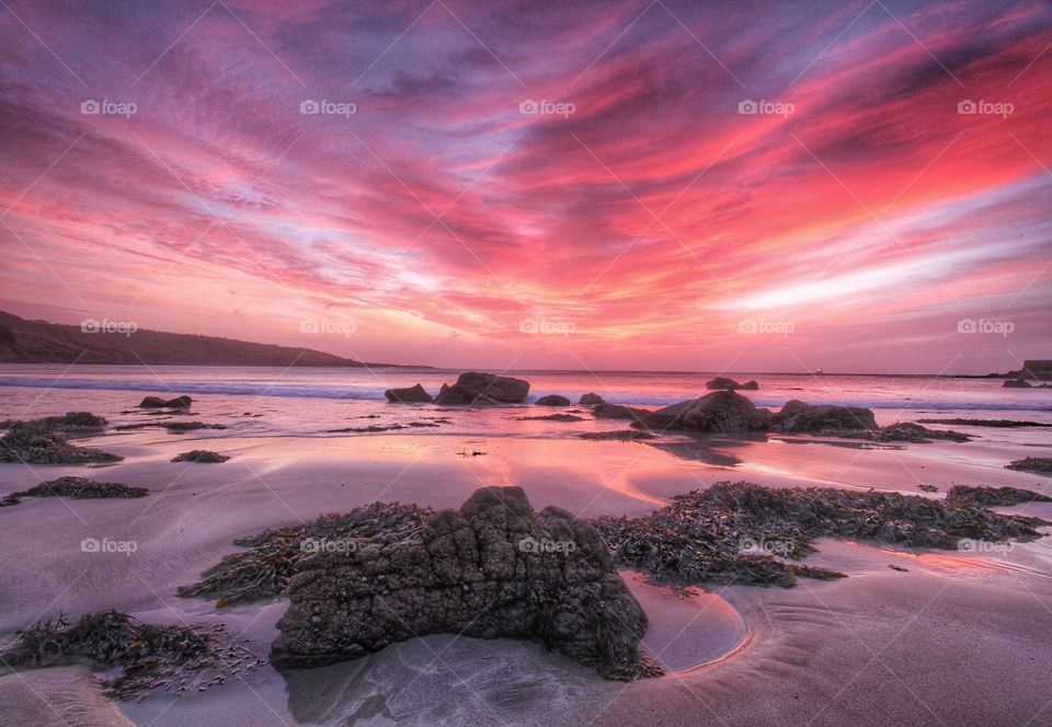 Red Sky Sunrise. Early morning at the beach as the sky is coloured red by a beautiful sunrise.