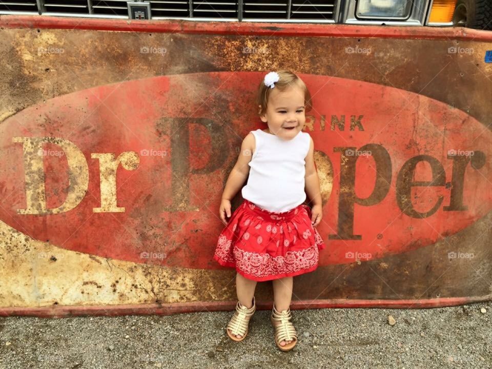 Large rusty Dr Pepper sign and my baby girl 
