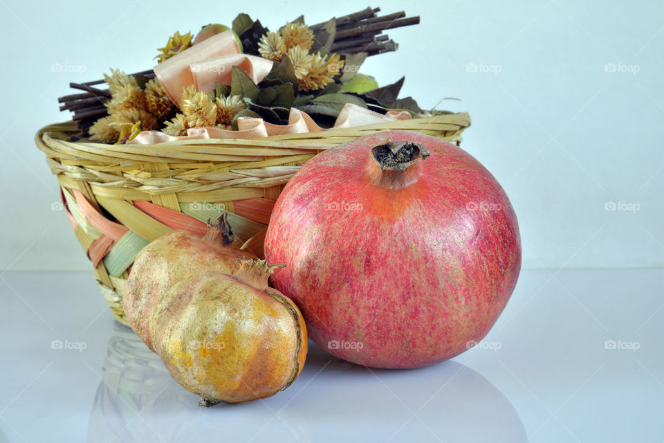 Close-up of a pomegranates and basket