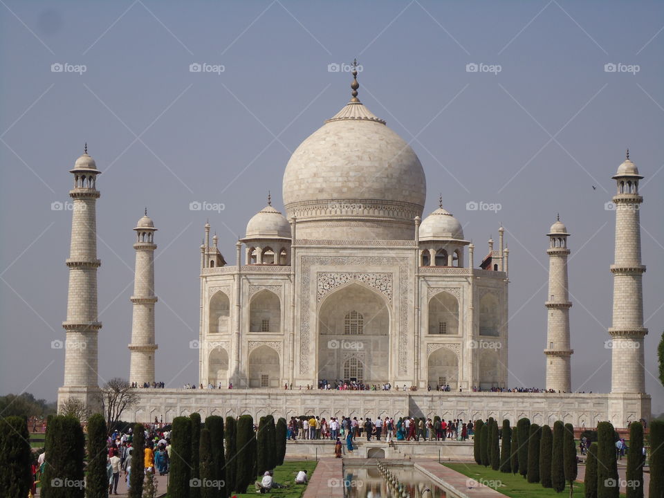Taj Mahal in Agra in India. It's one of the most popular tourist attractions in India and is made of white marble and one of 7 wonders of world. It was built by Mughal Emperor Shahjan in memory of his wife Mumtaj Mahal.