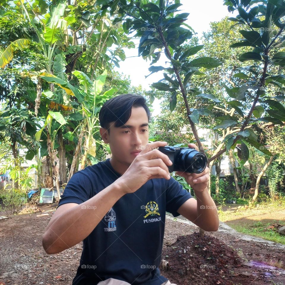 young man who is aiming at an object