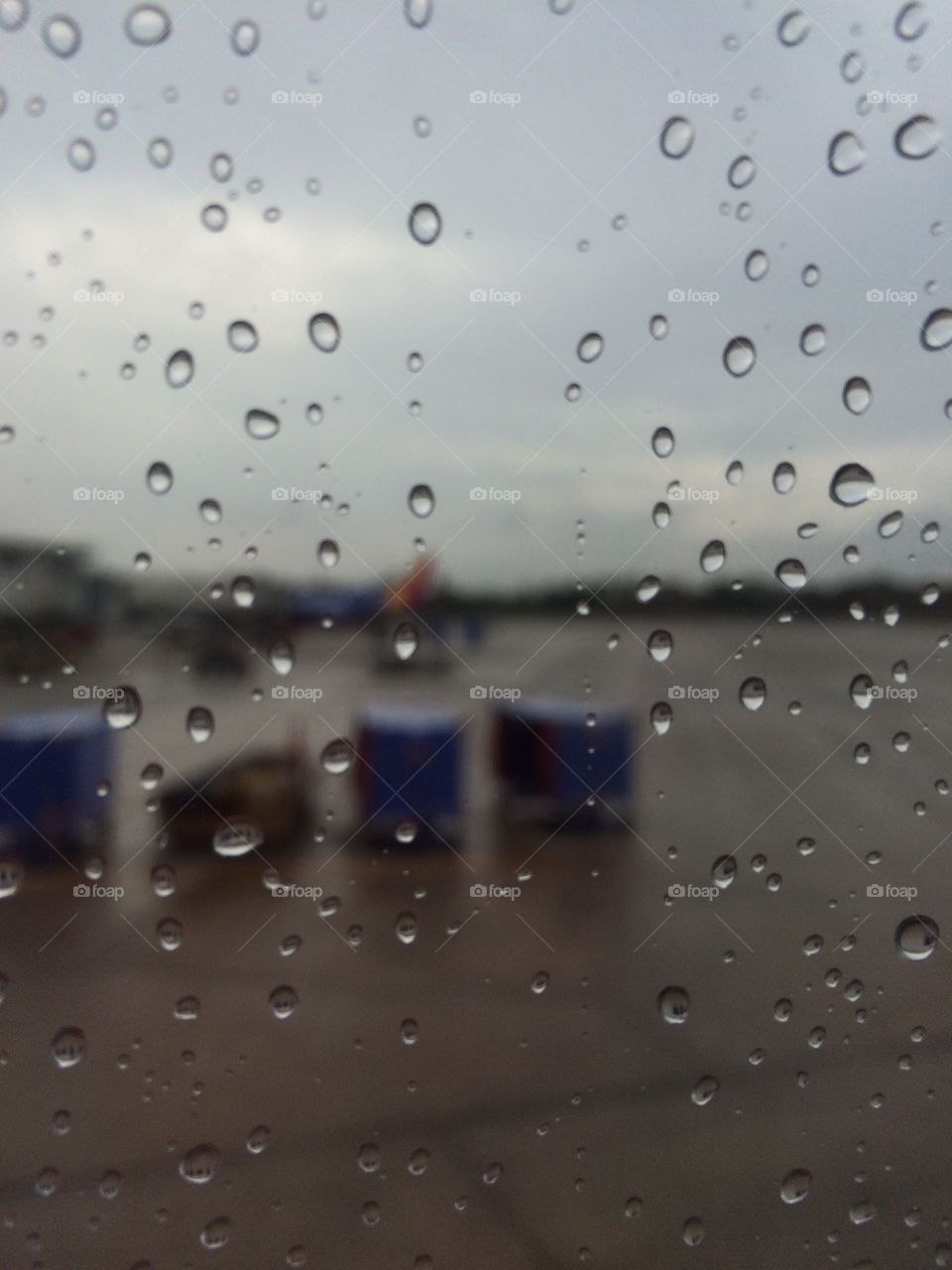 Rain on window from inside of the plane.