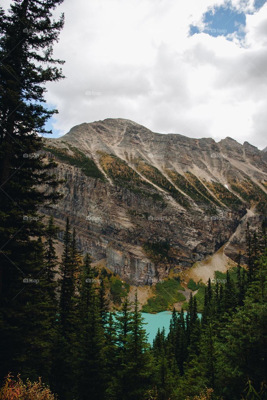 Canadian Rockies mountains in Alberta with teal blue water and snowy peaks