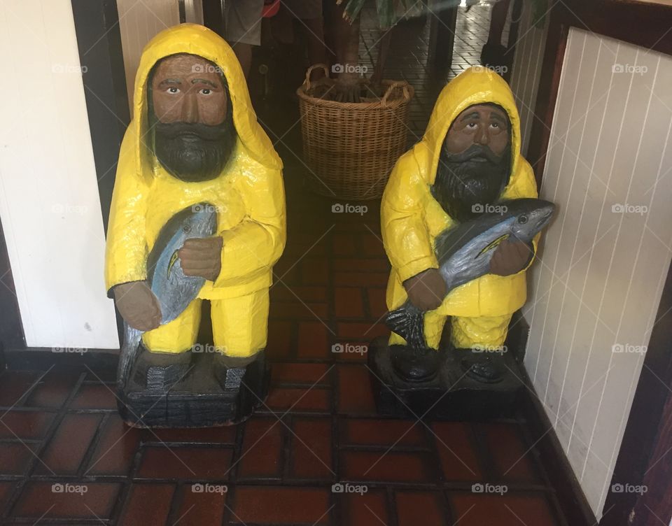 Little yellow fishermen statues