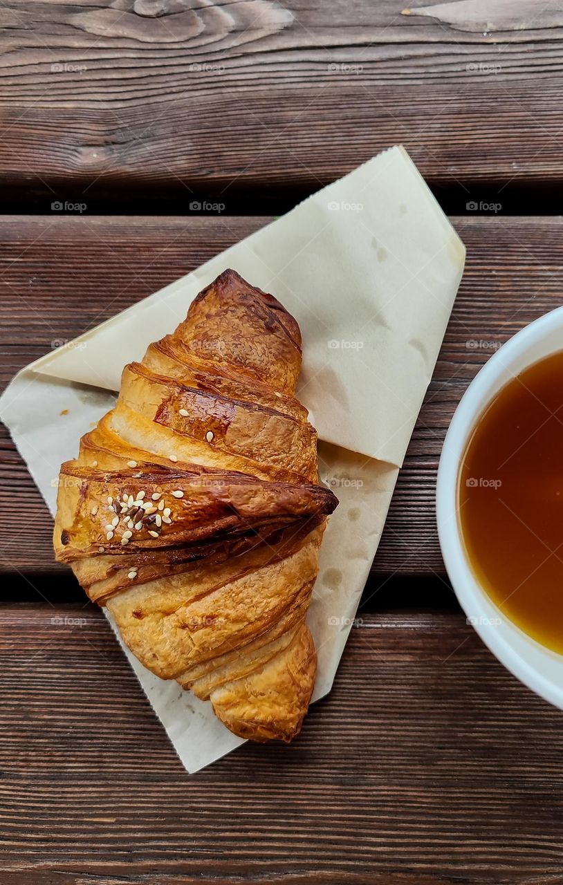 Croissant and tea on the table