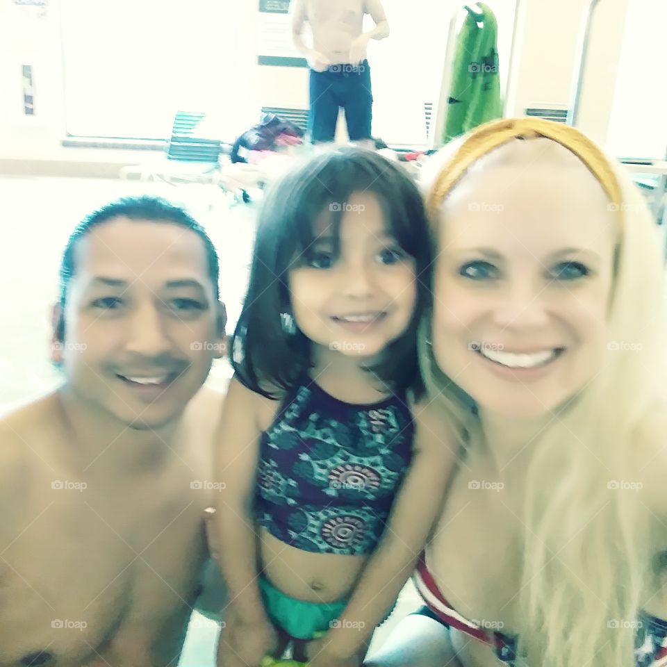 beautiful family in the swimming pool