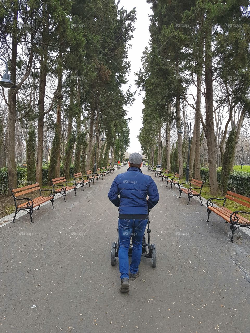 A father walking with his baby in the park