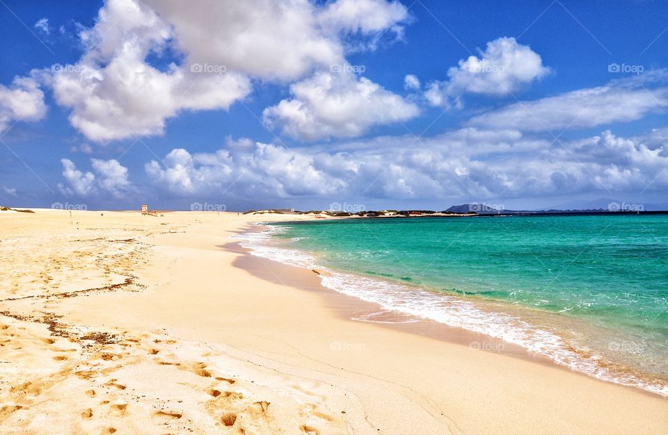 corralejo beach on fuerteventura canary island in spain - cloudy sky and turquoise water