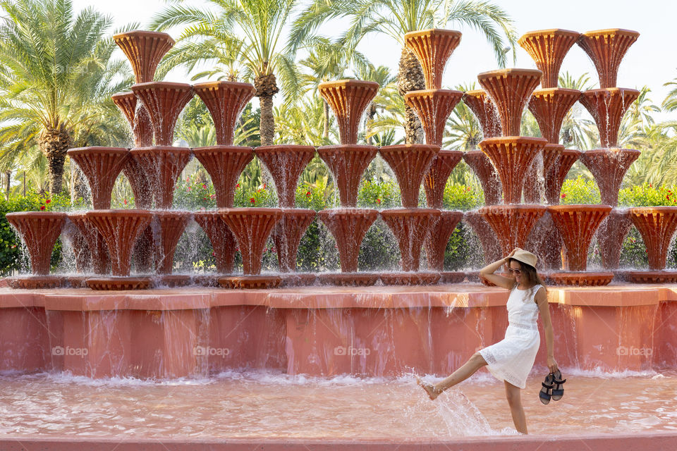 Girl having fun in the fountain