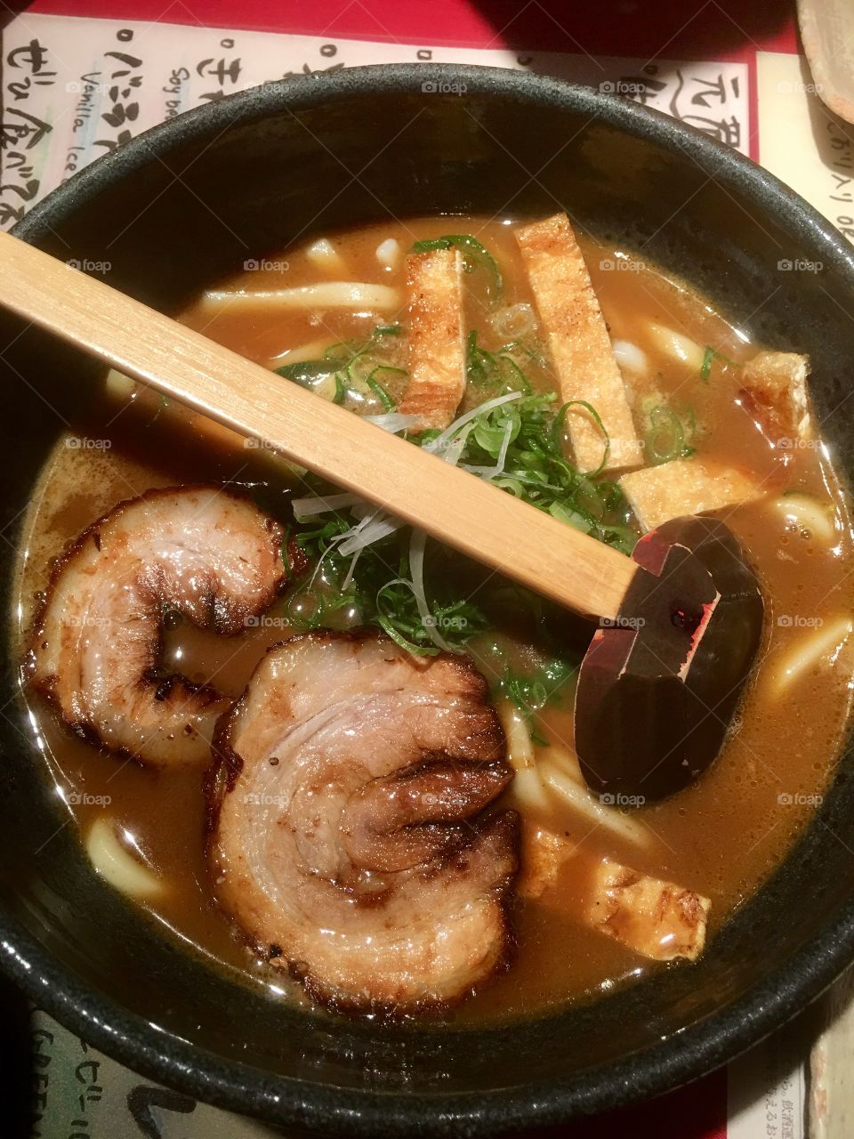 A great Pork Ramen soup with bamboo ladle. 