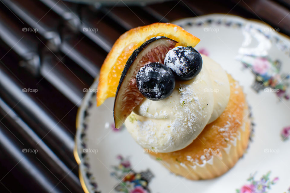 Cupcake with fig, orange and blueberry with frosting 