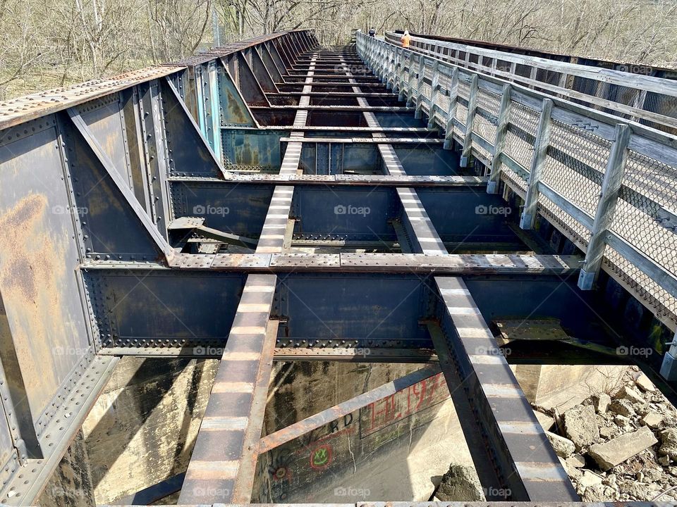 An old railway bridge and a footpath across a river 