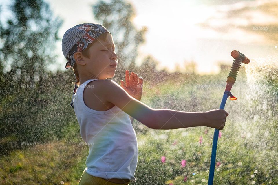 child boy spends summer holidays in the countryside, fun