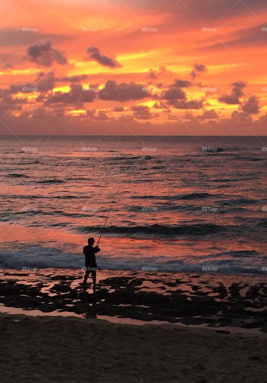 Fisherman at sunset, Hawaii
