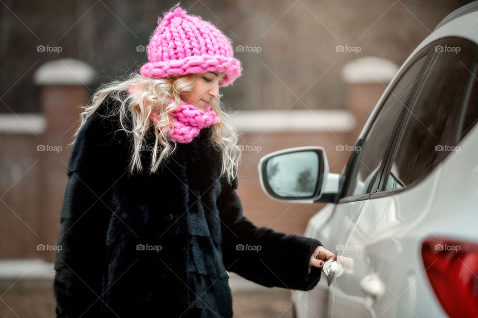 Outdoor Portrait of blonde woman in pink crochet accessories 