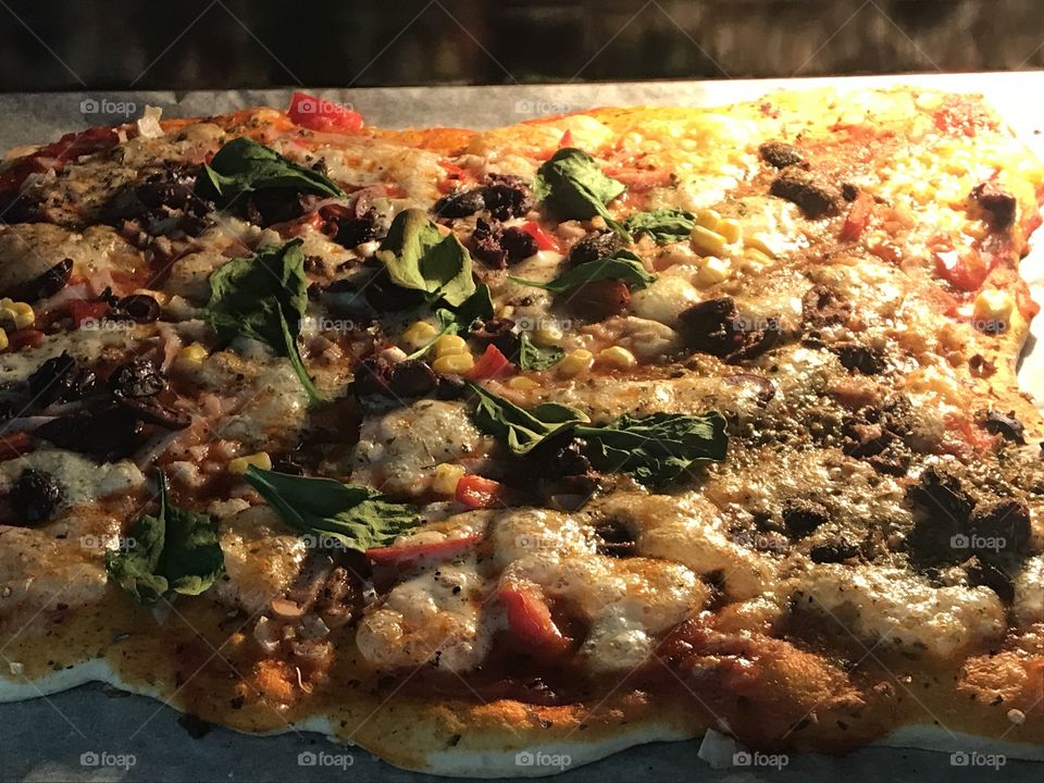 Pizza baking in oven