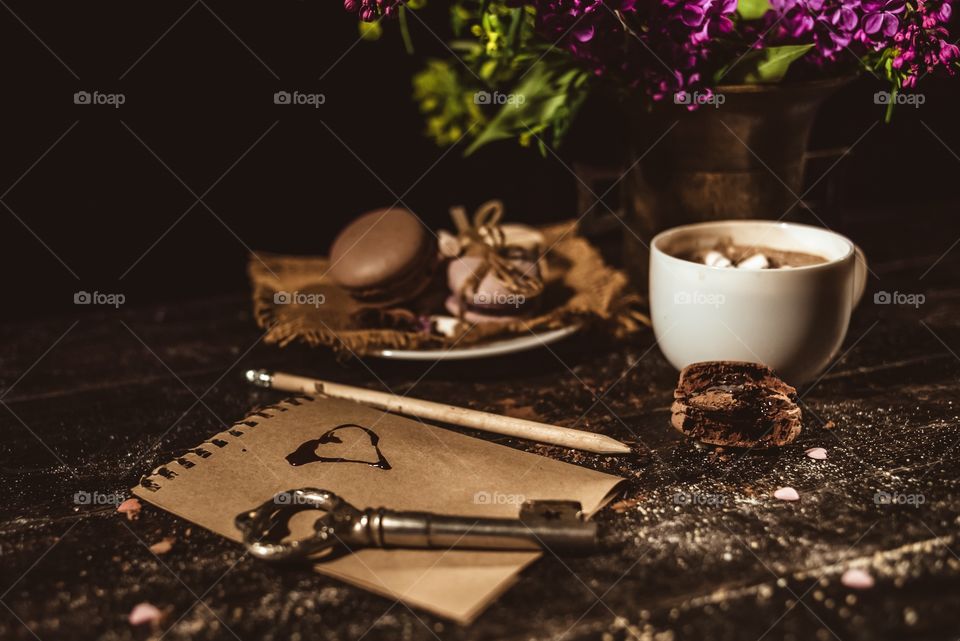 Hot chocolate with macaroons on a wood table 