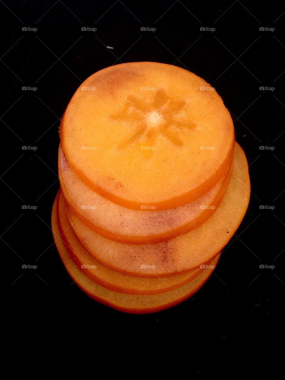 persimmon slices on black 