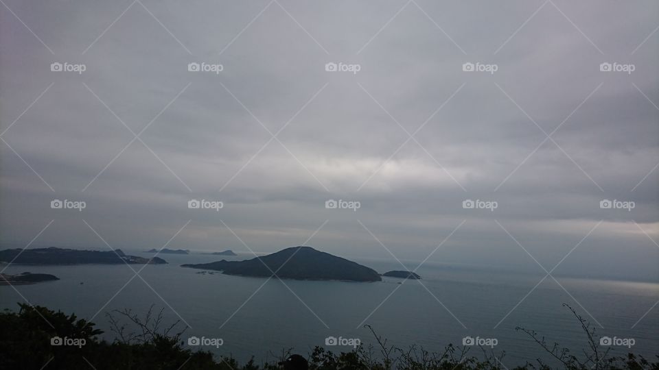 ocean, island, and cloudy sky