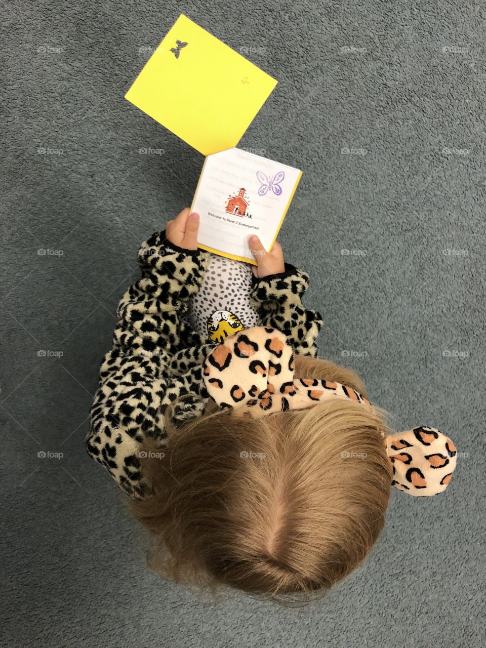 Cheetah girl on the first day of school ready a book