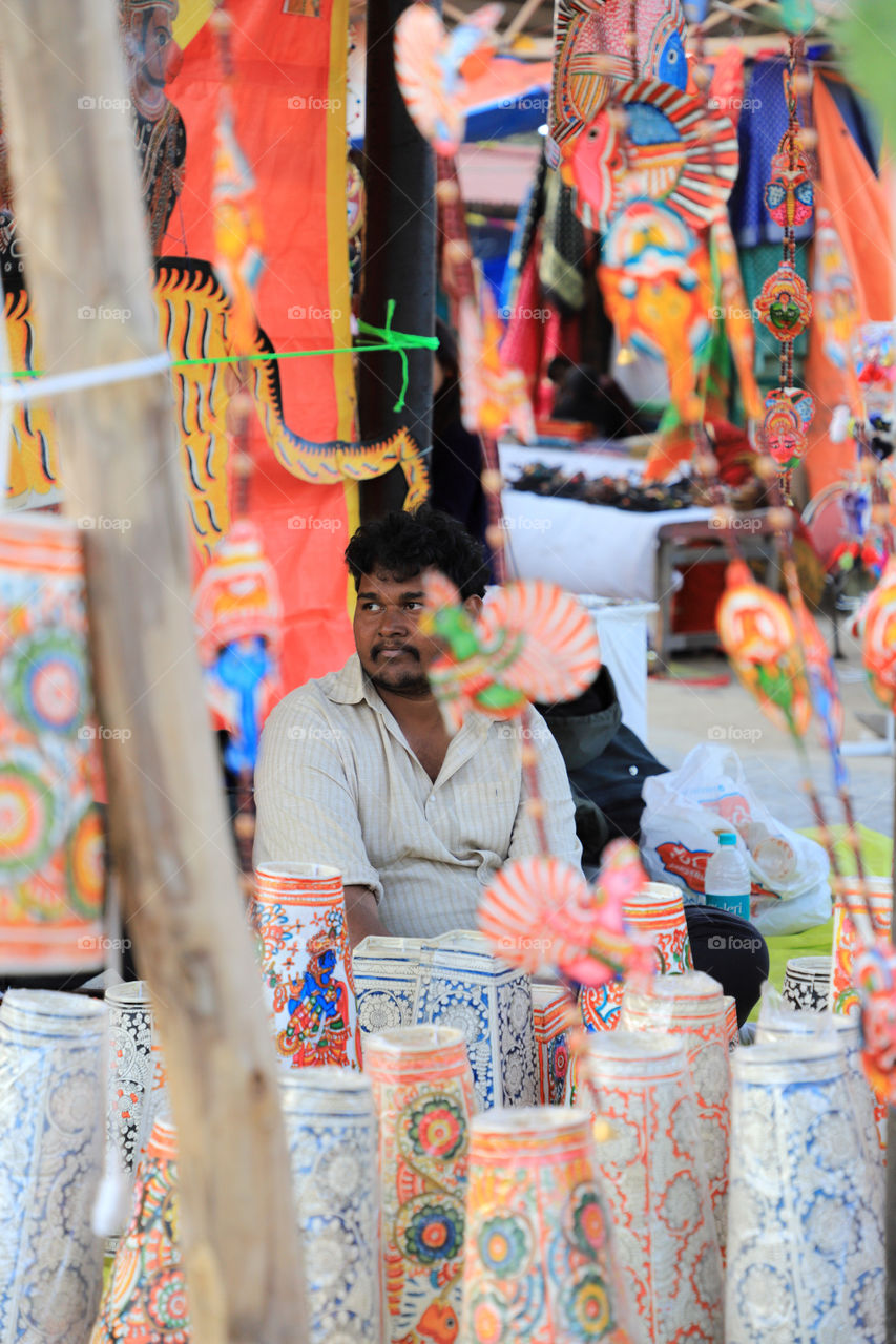 An  accomplished man selling handmade paper stuff