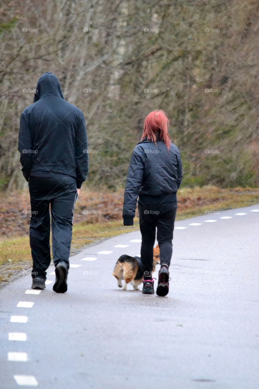 Rear view of people walking on road