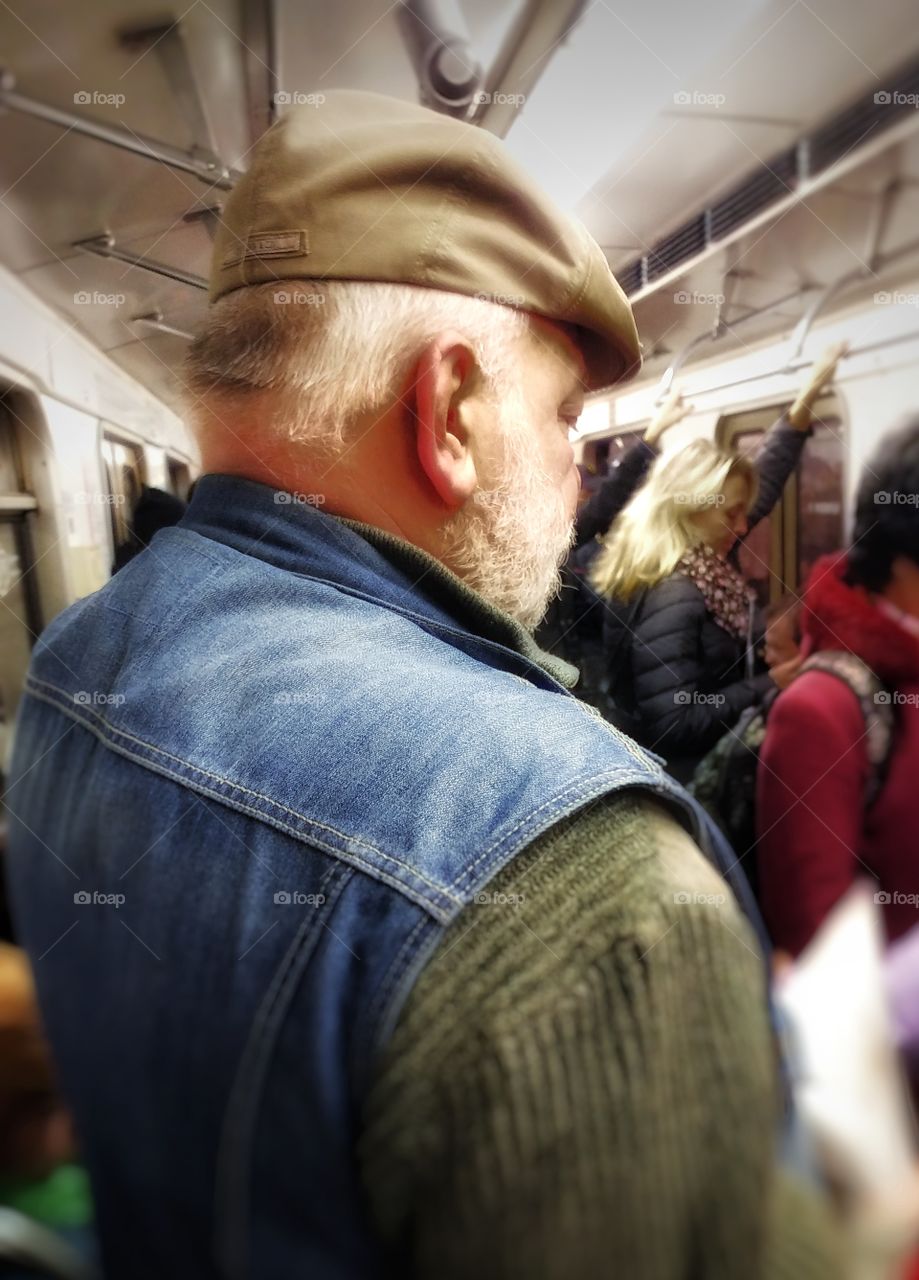 I was riding a subway near this man. He was standing out. 