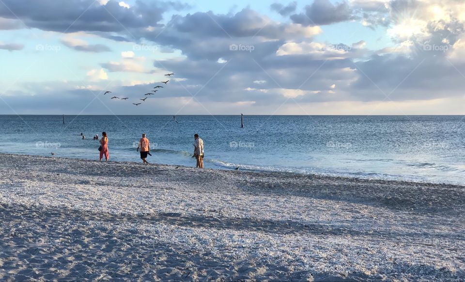 People enjoying oceanside beauty.