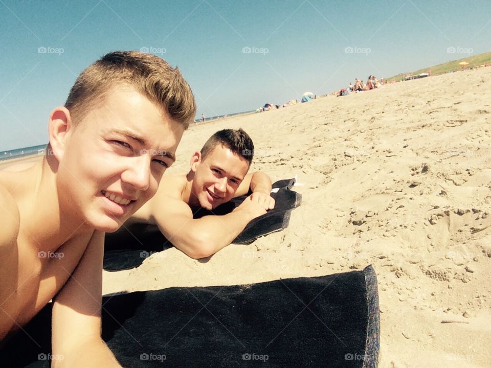 Sunny beach day. Two good looking guys on the beach 😃😍