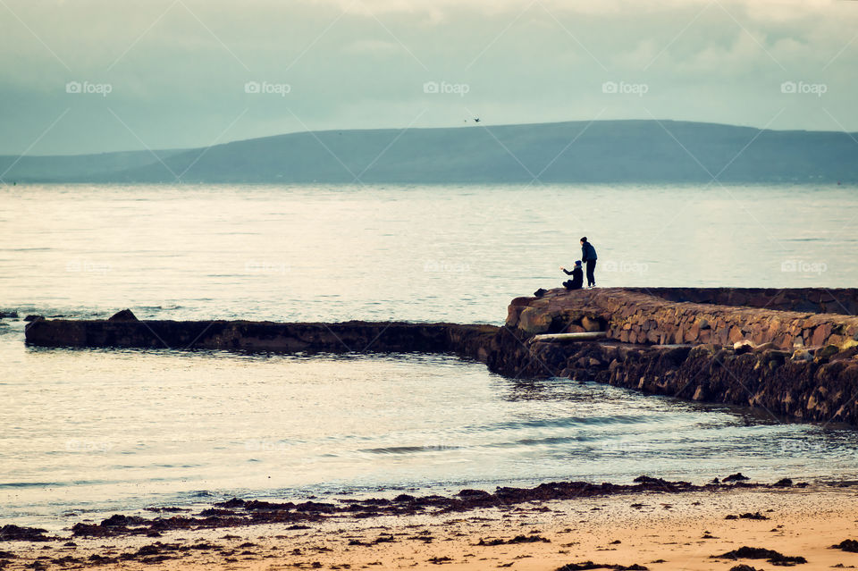 Couple on the dock by the beach