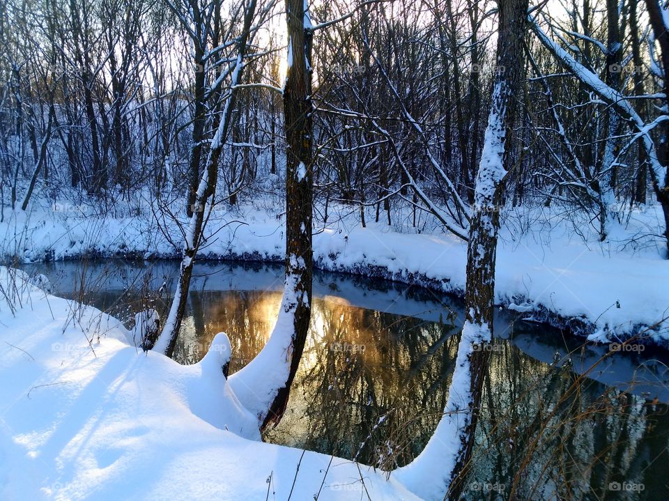 The glare of the sun in the winter river