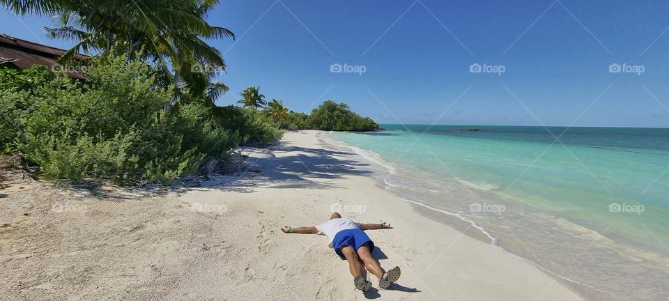 sensación de libertad acostado en una playa paradisíaca y solitaria