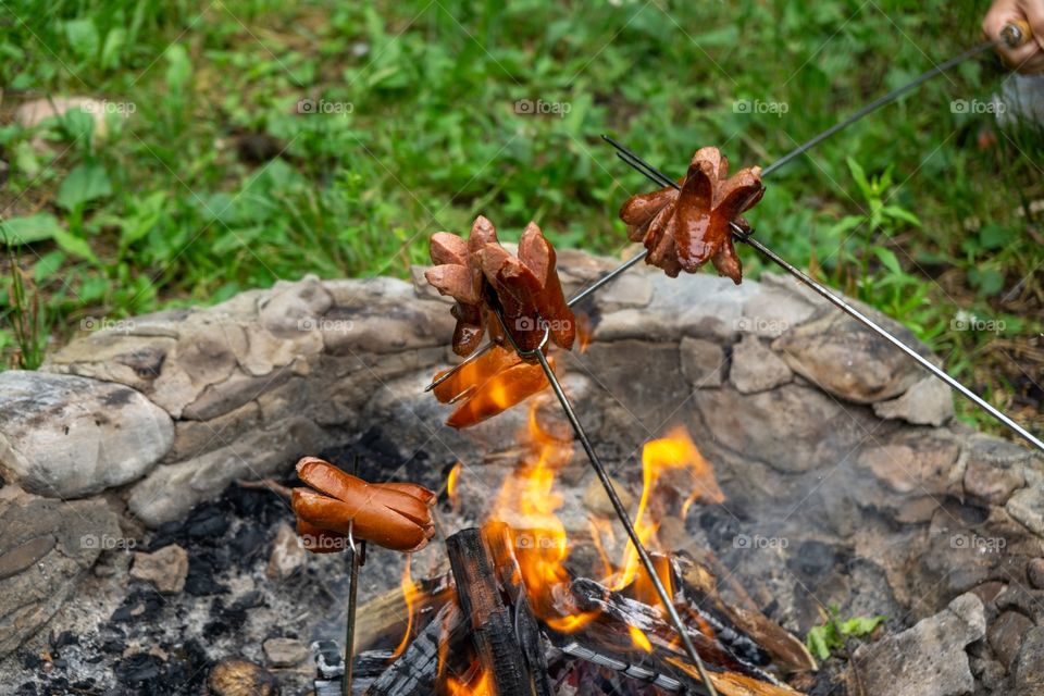 Sausages in fire during barbecue