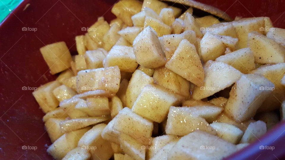 chopped up apples in a bowl in seasoned ready to make fresh homemade apple pies