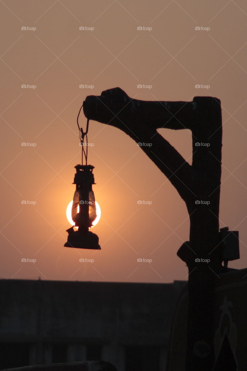 A lantern in front of sun