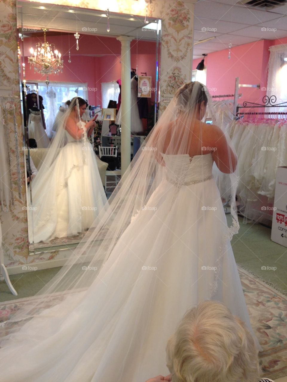 Trying on bridal gowns with veil
