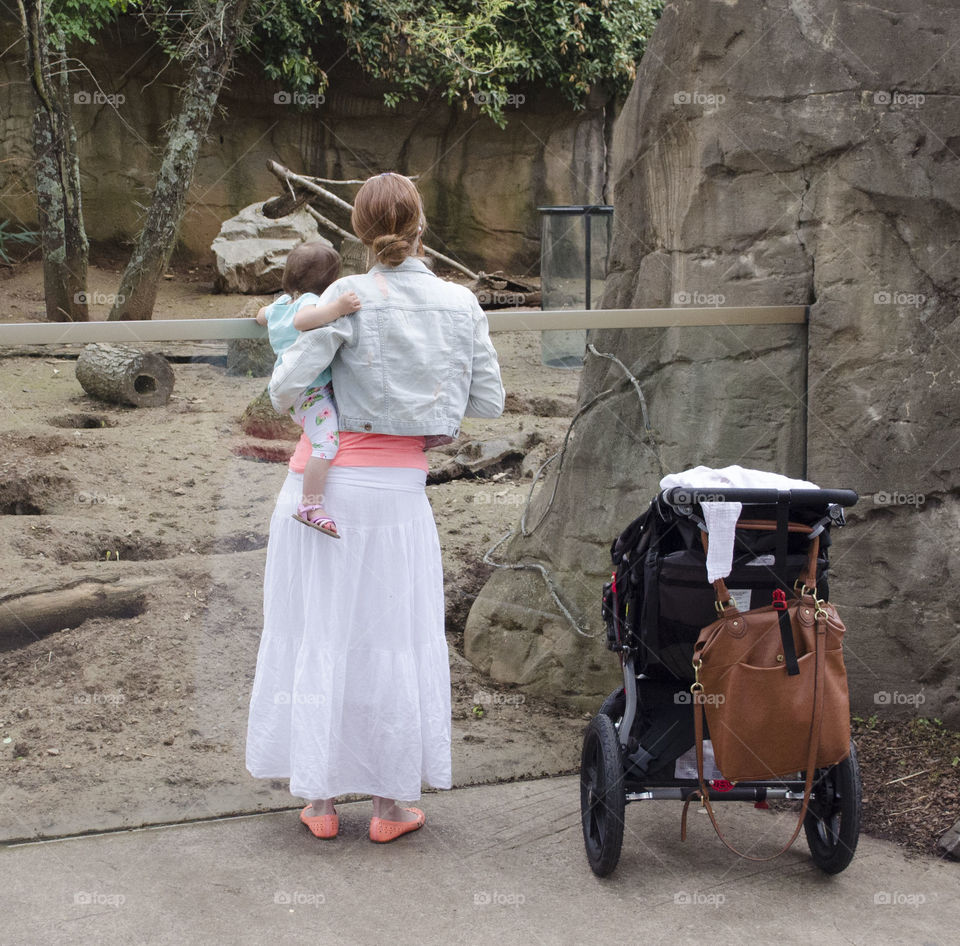 mom and daughter. enjoying the zoo