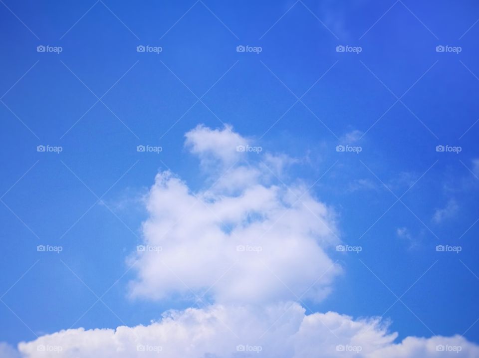 Blue sky with white clouds background.