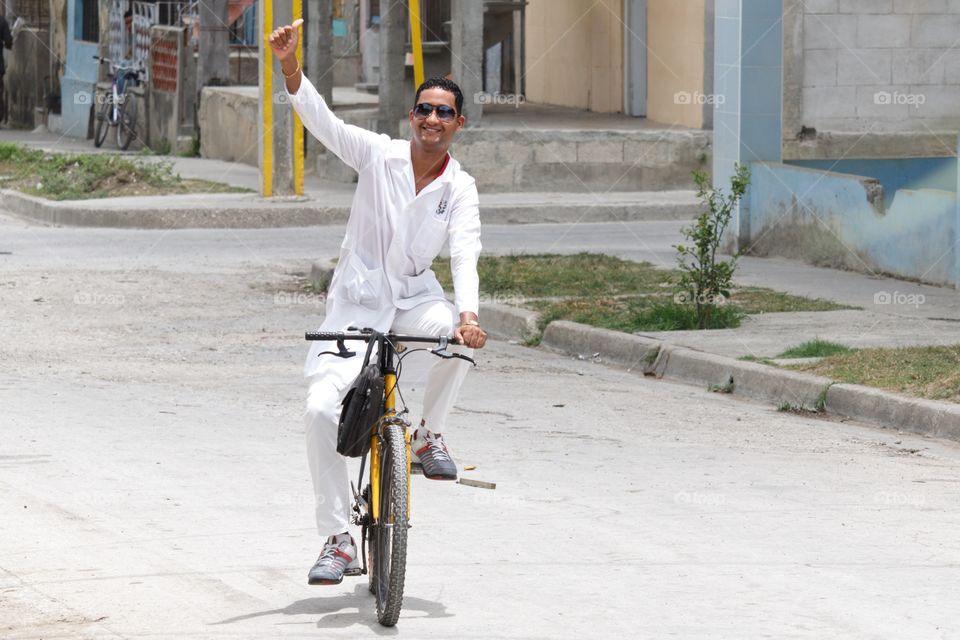 Cuban People.Medicine doctor coming back from work in his bicycle.