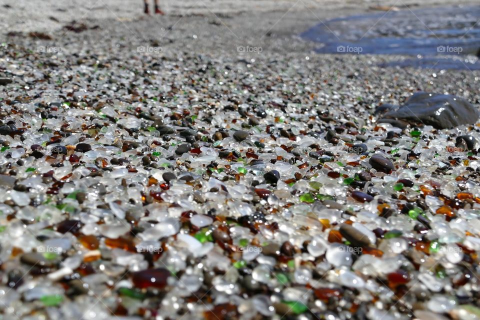The Glass Beach located on the coast of California. The sea glass is a result of a nearby dump that put the trash into the sea. Years after the dump was closed down, an abundance of sea glass began to turn up on the beach nearby.