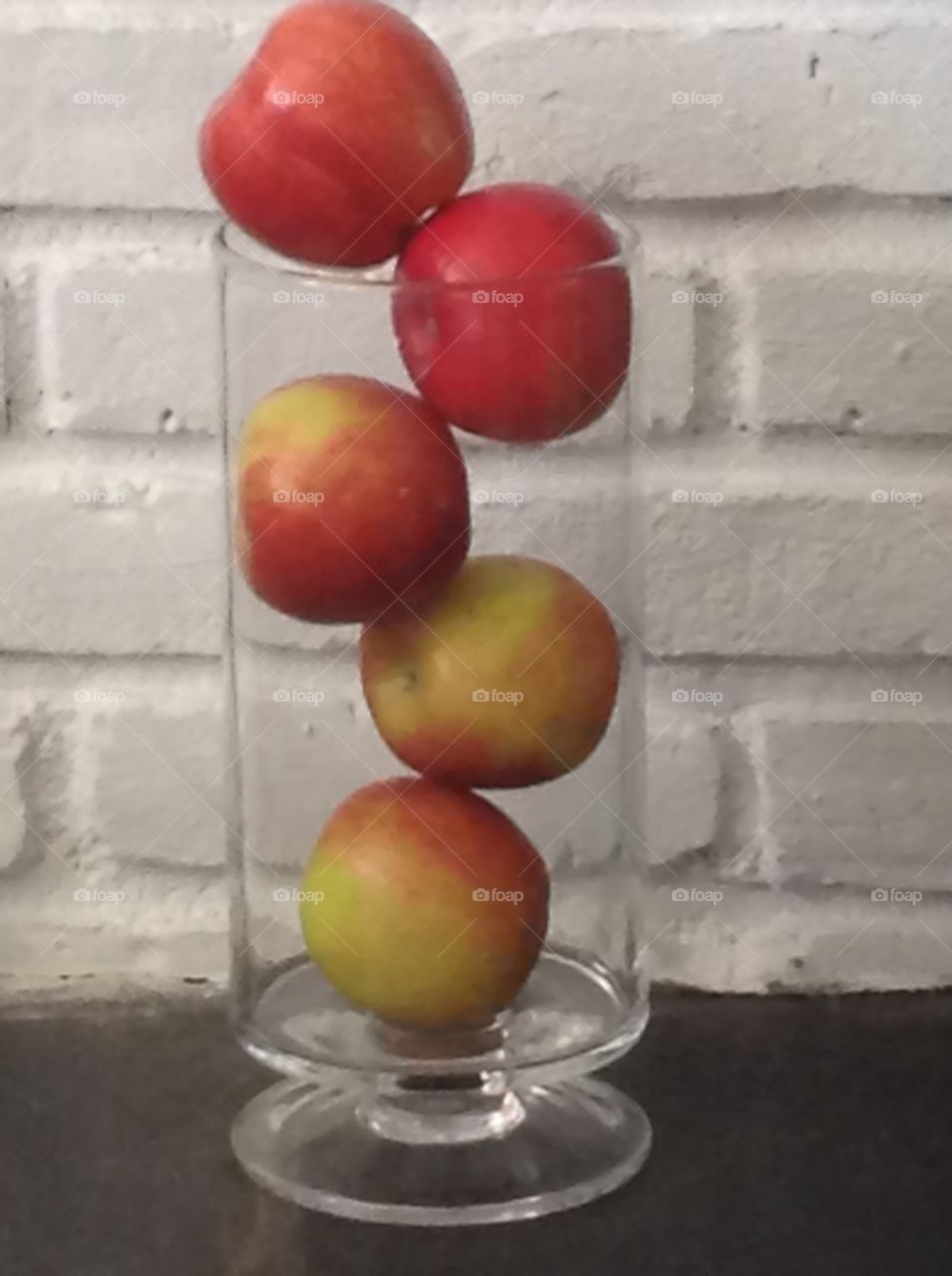 Apples in a vase as a centerpiece for a table.