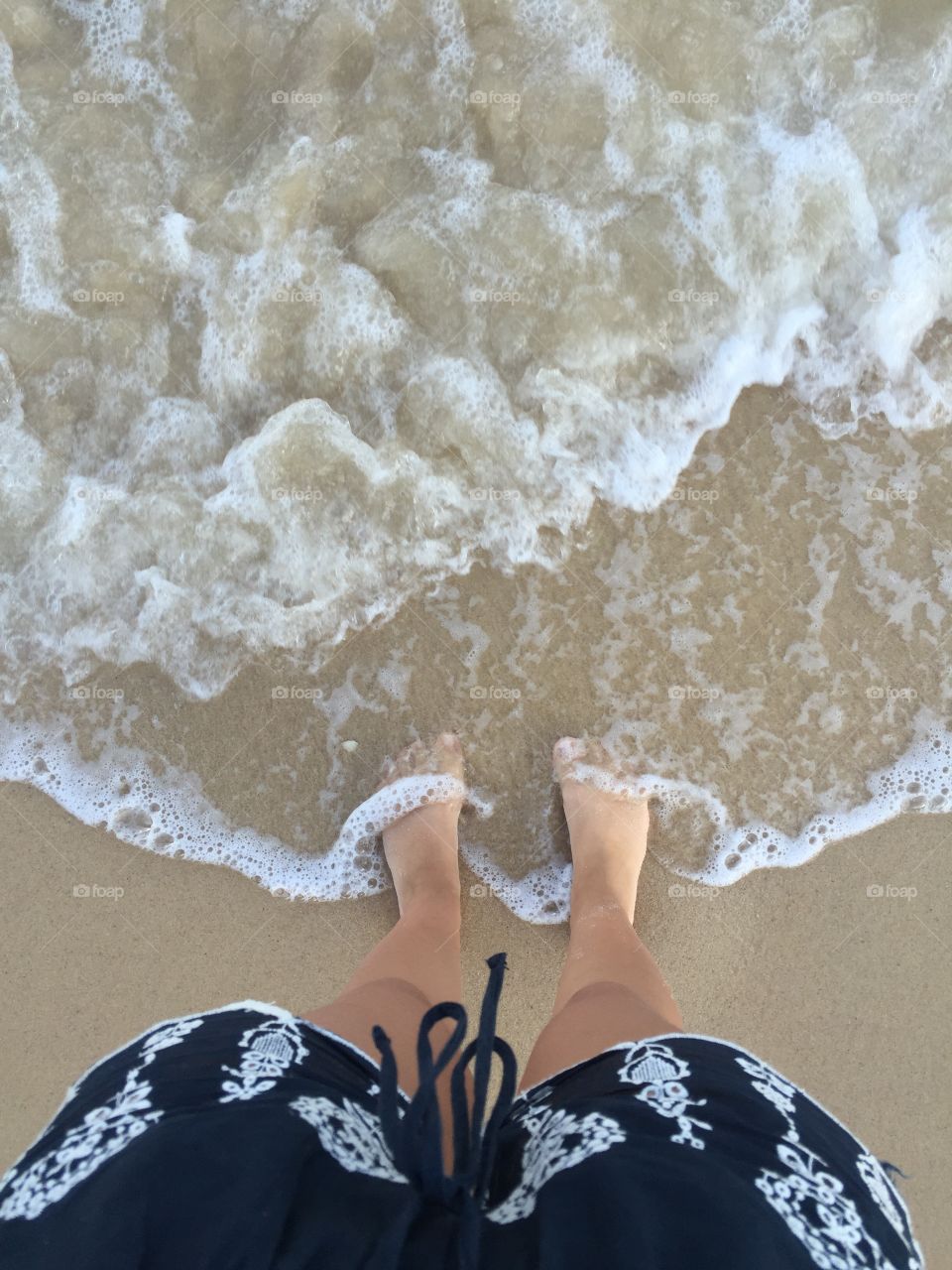 Low section of person on sandy beach